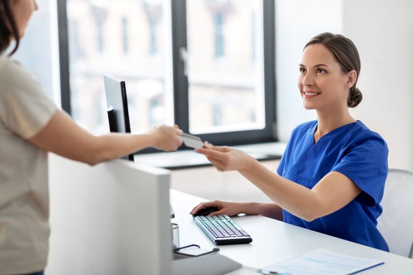 medical assistant checking in a patient